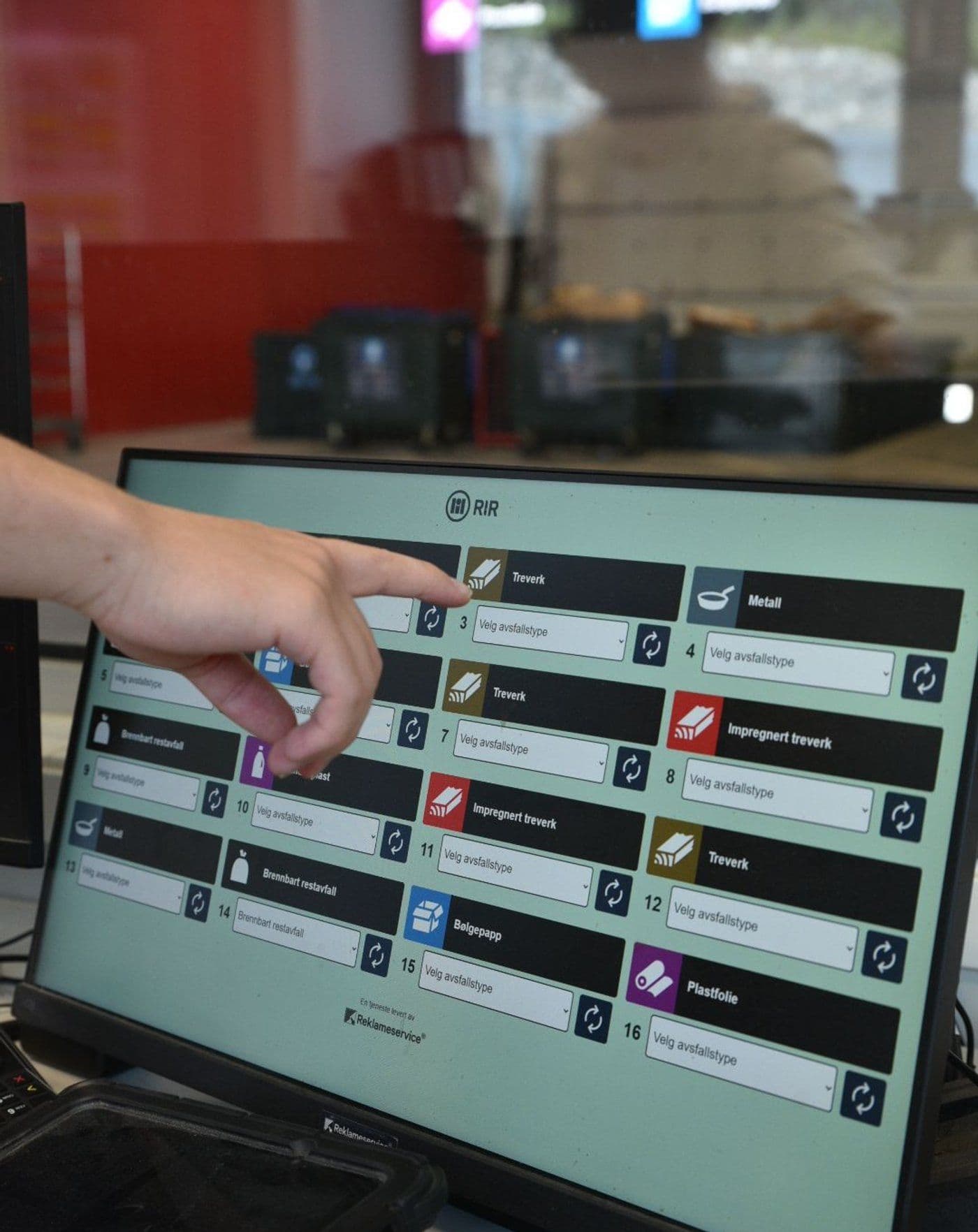 Employee using touch screen to select waste type at recycling station — custom control system by LEDFRONT